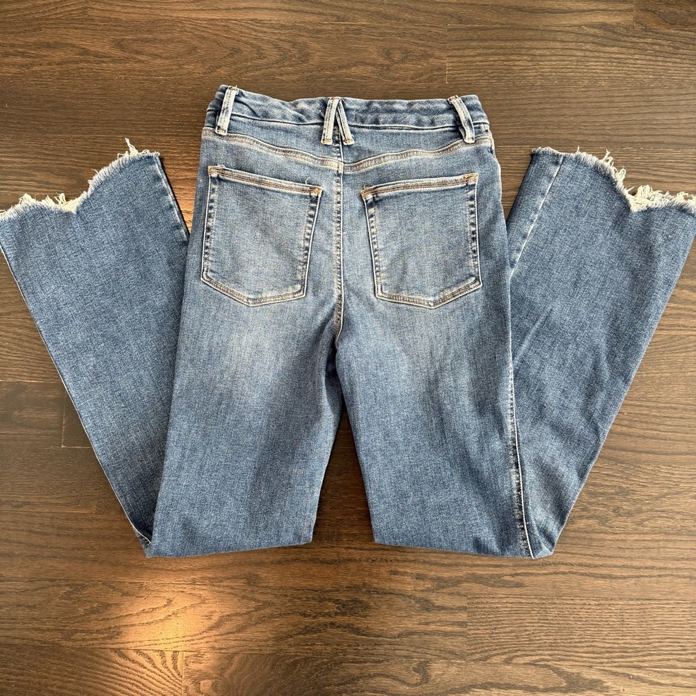 Good American Light Blue Flared Jeans with Frayed Hem